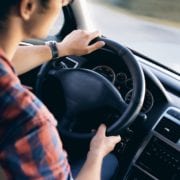 Woman driving car safely symbolizing the importance of auto insurance