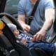 Baby Boy in Car Seat and Parent Buckling him up