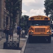 Yellow School bus on busy city street