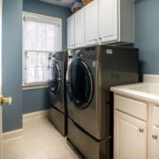Black washer and dryer machine in a laundry room